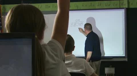 Teacher doing a problem on the board Stock Footage 12008327