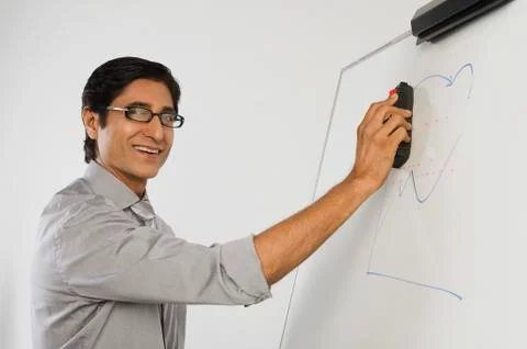 Teacher dusting a whiteboard Stock Photos