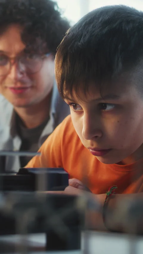 Teacher Educating Programming to Smart Young Boy in Modern Classroom Stock Footage 311809007