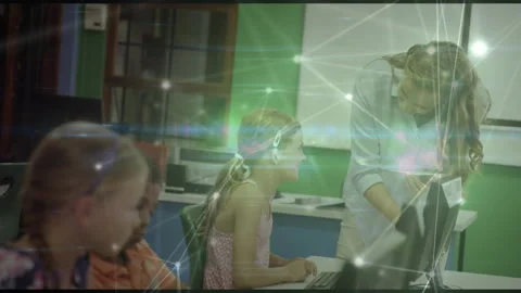 Teacher entering lab leaning over student keyboard, guiding coding while digital Stock Footage 316190890