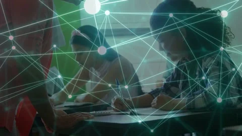 Teacher entering left, leaning over desks in classroom, checking students work, Stock Footage 333632181