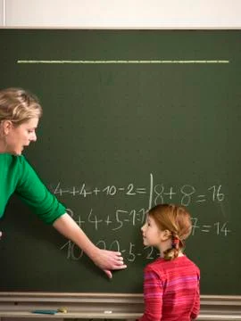 Teacher explaining arithmetic problem to girl (4-7) Stock Photos