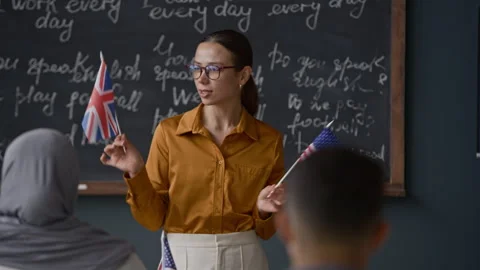 Teacher Explaining Difference Between British and American English During Lesson Stock Footage 314834574