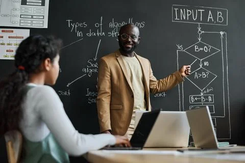 Teacher explaining formula on blackboard Stock Photos