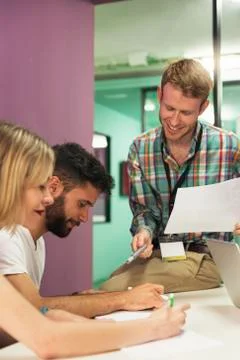 Teacher explaining the lesson to his students. Stock Photos