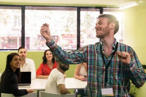 Teacher explaining the lesson to his students. Stock Photos