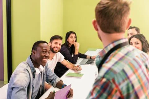 Teacher explaining the lesson to his students. Stock Photos