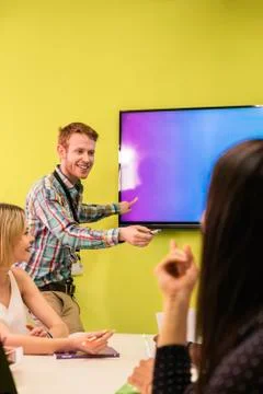 Teacher explaining the lesson to his students. Stock Photos