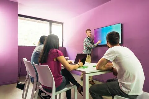 Teacher explaining the lesson to his students. Stock Photos