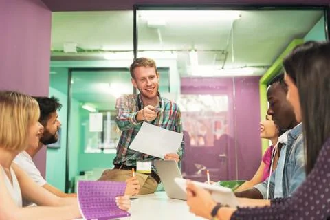 Teacher explaining the lesson to his students. Stock Photos