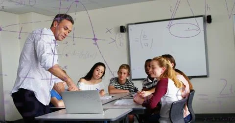 Teacher explaining math concepts to attentive students in classroom, using Stock Illustration