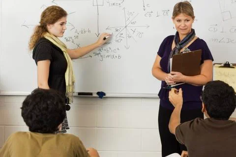 Teacher explaining mathematics to students in classroom 写真素材