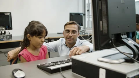 Teacher explaining schoolgirl material on computer science. Stock Footage 153834185