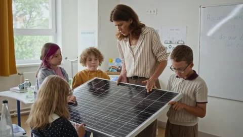 Teacher Explaining Solar Panel to Elementary Students in Classroom Stock Footage 345239678