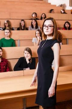 Teacher explaining something to students Stock Photos