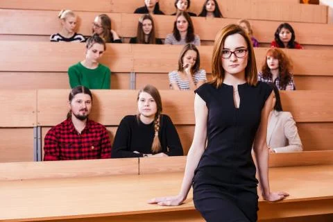 Teacher explaining something to students Stock Photos