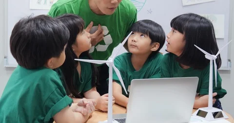 Teacher explaining to student in classroom about ecology project. Stock Footage 111408110