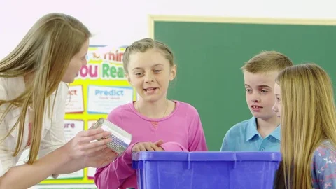 Teacher explaining to students about recycling Stock Footage 80131631