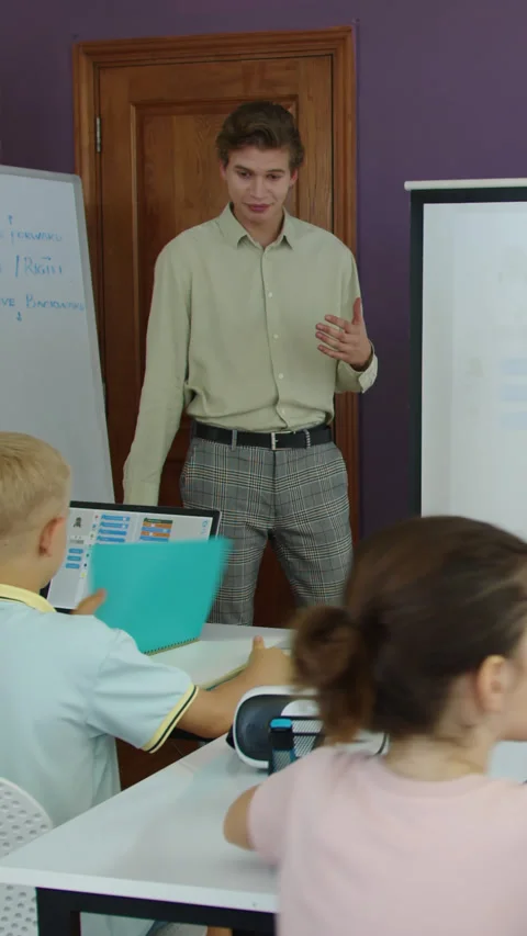 Teacher Explaining Topic to Group of Kids at IT Class Stock Footage 280638294