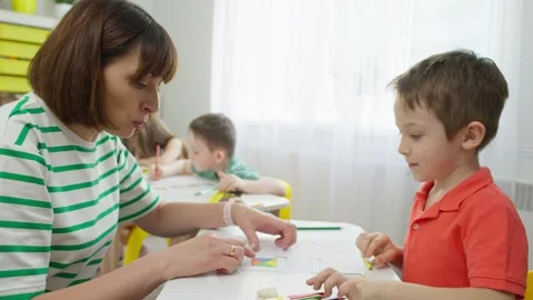 The teacher explains the conditions of the task to the child. Stock Footage 253806221