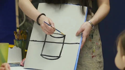 Teacher explains how to draw a vase Stock Footage 90565093