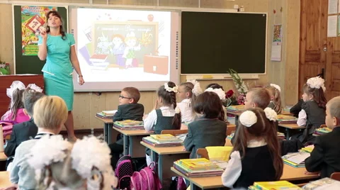 Teacher explains the lesson for pupils in school. September, 1 in Russia Stock Footage 41441267