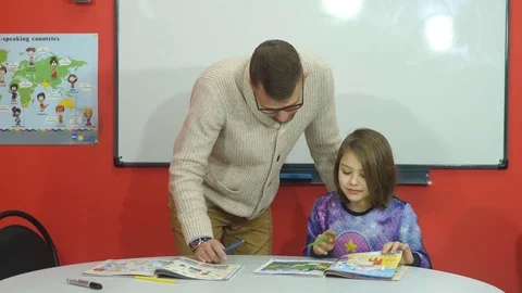 The teacher explains the school school material Stock Footage 70601425