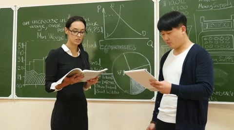 Teacher Explains a Subject to Student Stock Footage 61202867