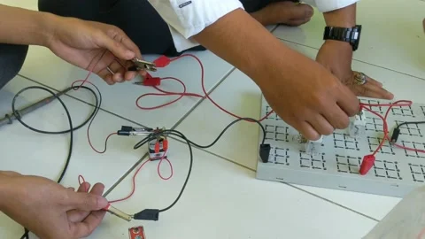 A teacher gave an example of stringing electrical wires Stock Footage 221381154