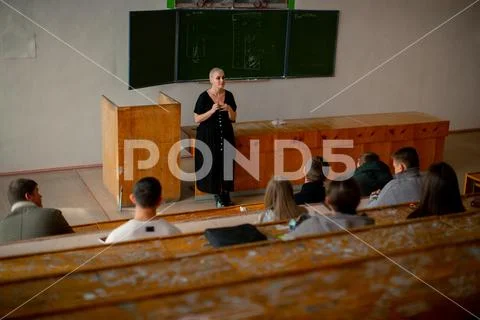 The teacher gives a lecture in the classroom Stock Photos
