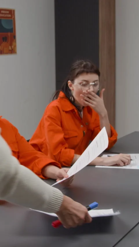 Teacher Giving Test Sheets to Inmates during Class Vertical Stock Footage 329002851