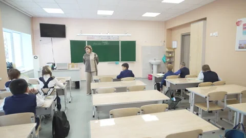 Teacher guides elementary class through structured lesson Stock Footage 310243774