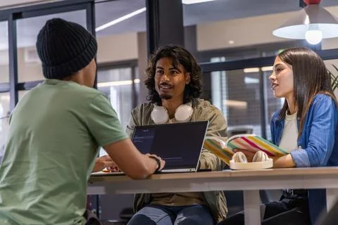 Teacher guiding learner by writing eight German genitive sentences in text Stock Photos