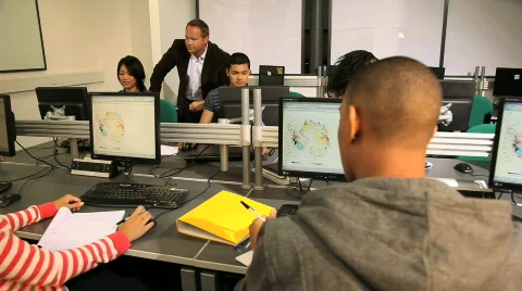 Teacher guiding student in computer class Stock Footage 832441
