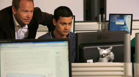Teacher guiding student in computer class Stock Footage 832448