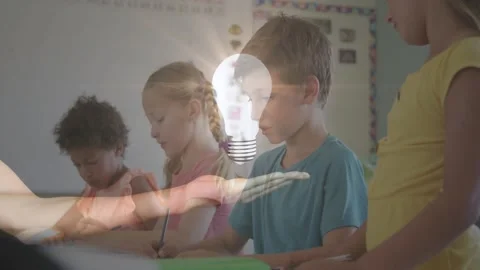 Teacher hand entering, presenting lightbulb graphic and sparking students Stock Footage 328331064