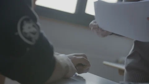 Teacher is handing tests 動画素材 100978084