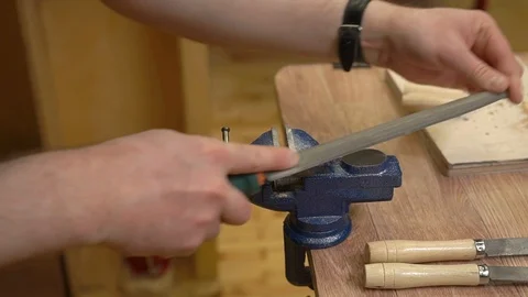 Teacher hands polish plexiglass fixed in blue metal vice Stock Footage 127111491