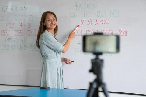 Teacher happily explaining virtualy math exercises to the students Stock Photos