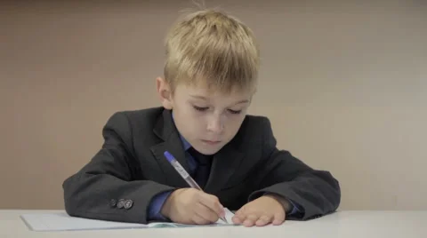 Teacher help boy write Stock Footage 68940277