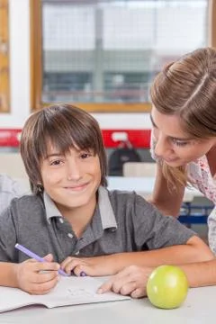 Teacher helping a boy Fotos Stock