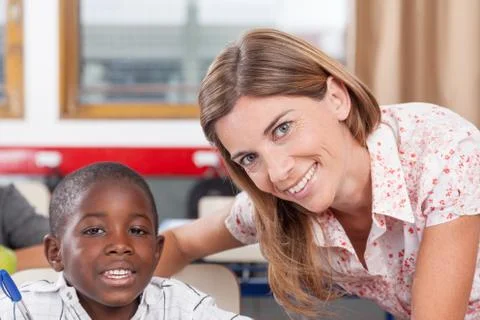 Teacher helping a boy 스톡 사진