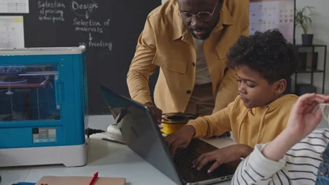 Teacher Helping Children with Coding on Laptops on 3D Printing Class Stock Footage 245452850