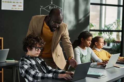 Teacher helping children in study Foto stock