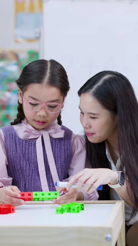 Teacher Helping Girl Learn Math With Counting Blocks Stock Footage 326747971