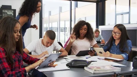 Teacher helping high school students with technology Stock Footage