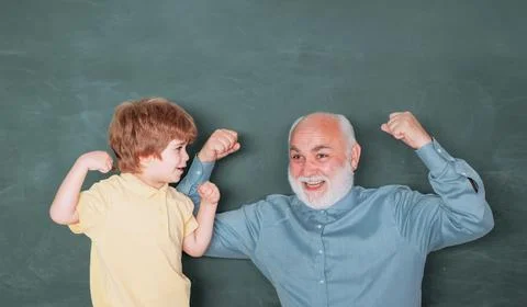 Teacher helping his teen pupil on education class. Concept of education and Stock Photos