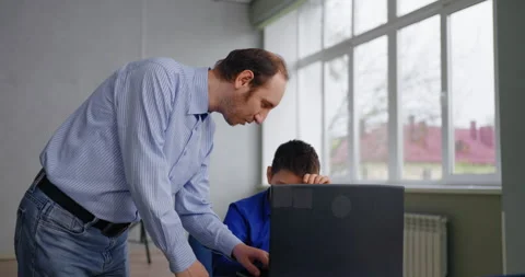 Teacher Helping To Little Pupil In Programming Classes For Children, Middle-Aged Stock Footage 280173196