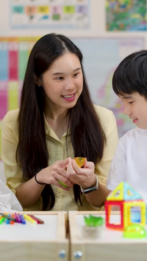 Teacher Helping Primary School Students Learn Math with Geometric Shapes Stock Footage 330101787