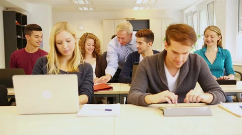 Teacher helping students in classroom Stock Footage 33291394